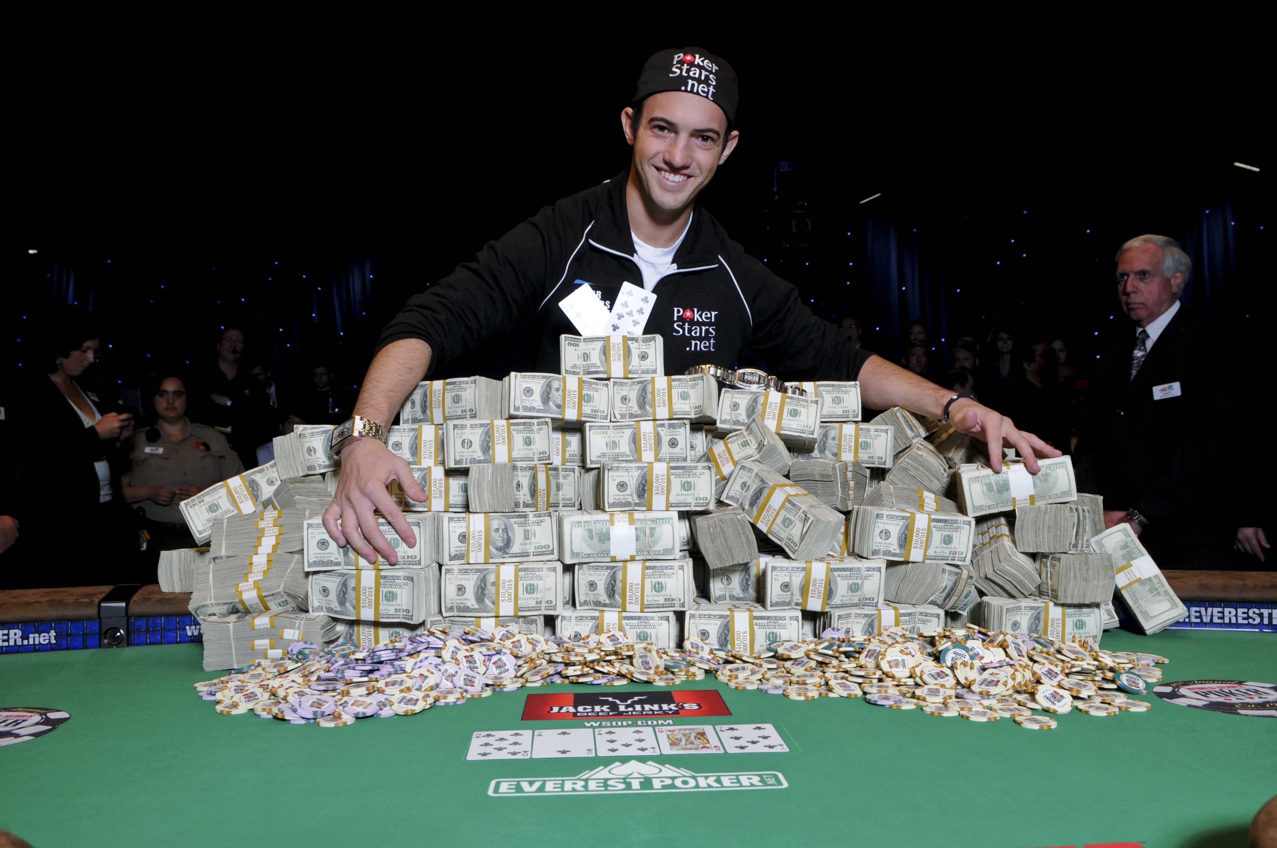 A poker player wears the World Series of Poker logo on his cap during the